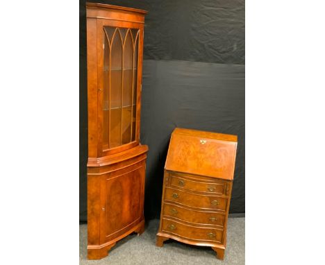 A late 20th century burr walnut bureau of narrow proportions, fall front enclosing a baize lined writing surface, pigeonholes