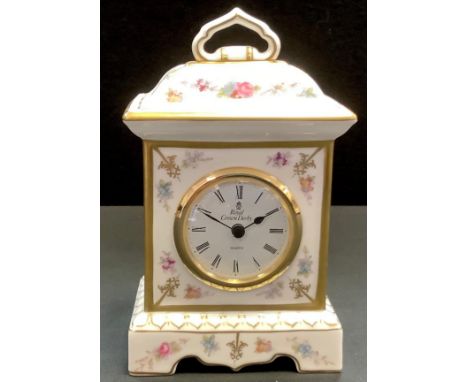 A Royal Crown Derby Royal Antoinette porcelain mantle clock, with floral decoration and gilding, boxed. 19cm high (second qua
