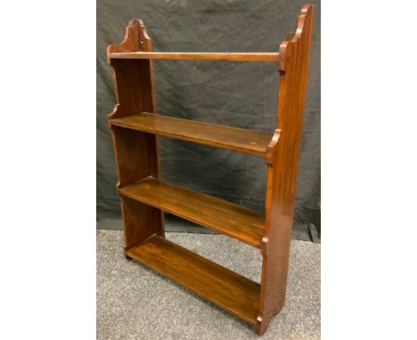 A late Victorian mahogany wall mounting book shelf, four open backed shelves, shaped sides and top, 87cm high, 59cm wide, 16.