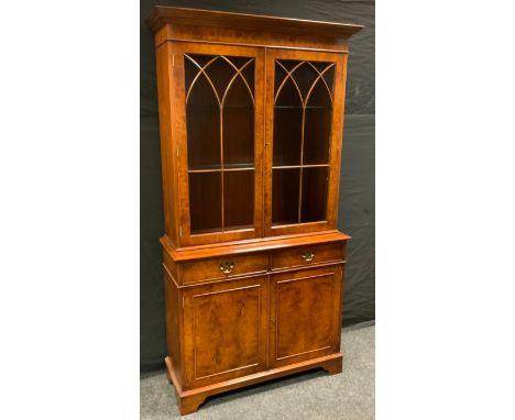 A late 20th century burr walnut library bookcase, moulded cornice above a pair of astragal doors enclosing adjustable shelves
