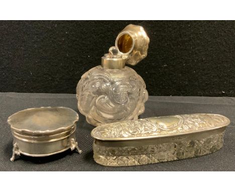 An  Edwardian globular scent bottle, moulded and etched with scrolls and flower heads, domed silver cover, marks rubbed;   a 