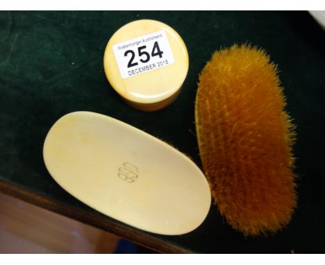 Ivory coloured snuff box and lid by Asprey of London and a similar pair of Gentleman's brushes, 