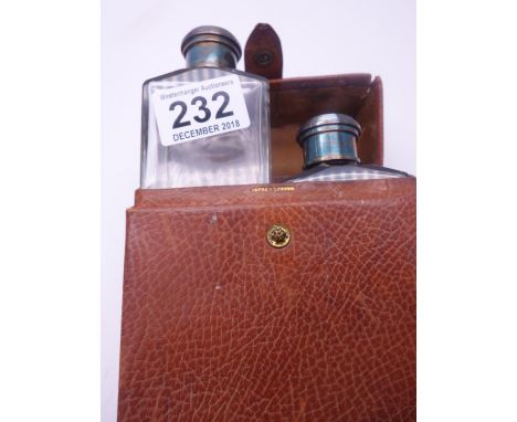 Asprey of London a superb snake skin cased double flask holder, the 2 glass bottles enclosed both with SILVERtops and measure