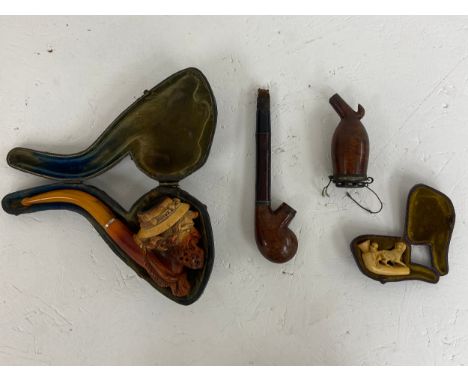 A mixed collection to include a figural Meerschaum pipe in a fitted case along a small Meerschaum style figure group pipe and