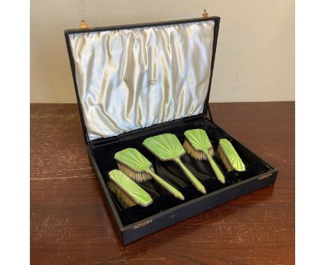 A silver hallmarked Art Deco vanity set to include four green guilloche brushes and a mirror in a fitted James R Ogden &amp; 