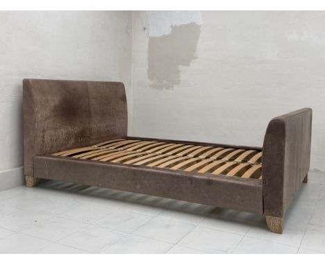 A contemporary bed frame having a simple distressed leather head and footboard - fits double 135 x 190 cm 4'6" x 6'3"