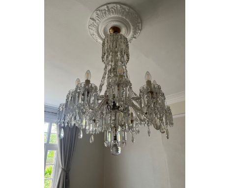 A large 20th century Murano or Baccarat style cut glass chandelier having a baluster form stem with scrolling branches termin