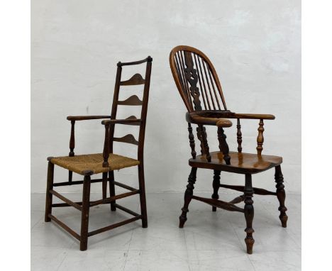 Two 19th century armchairs to include an elm ladderback elbow chair with rush seat raised on circular stretchered supports al