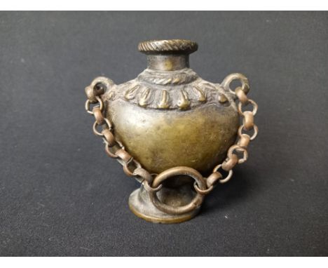 A 19th century Nepalese Newar or bronze inkwell in the form of a Kalashah or ritual vase suspended on a short belcher chain t