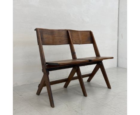 An early 20th century oak folding two seat chapel bench having a curved top rail over two saddle seats raised on flat stretch