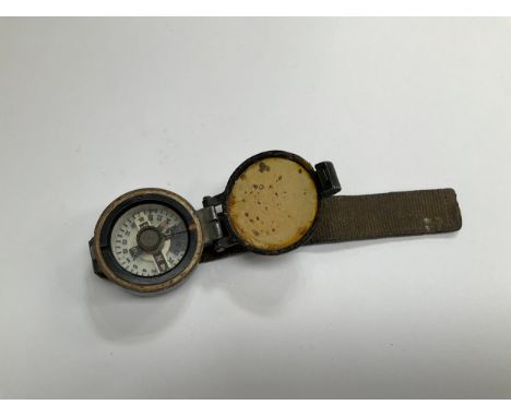 A WWII British wrist compass, stamped to rear 6B/2593, strap a/f 