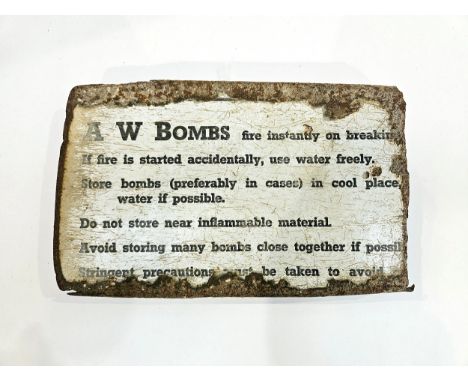 A WWII enamel sign from a case 'A W BOMBS fire instantly on breaking...' advising safe munitions storage information, curled 