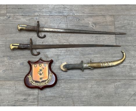 Two 19th Century French Gras bayonets, together with an Arabic dagger and Ordnance Corps plaque (4) 