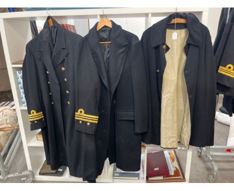 Two Royal Navy great coats including Bakelite buttoned, together with a cloak (3) 