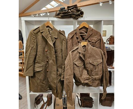A quantity of 1950's British Army uniform including battledress, trousers, greatcoat and putties, some mothing 