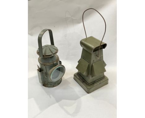 A WWII Blackout lantern in green together with a 1945 dated Railway hand lamp (2) 