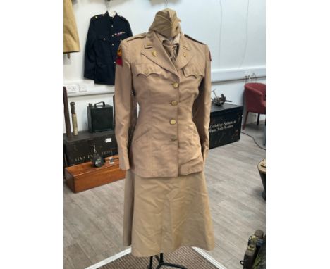A WWII US women's army uniform consisting of jacket, skirt, hat, blouse and belt with insignia, some mothing