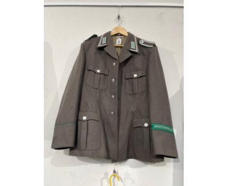 A West German Army Border Guard's jacket, 'GRENZTRUPPEN DER DDR' green band to sleeve 