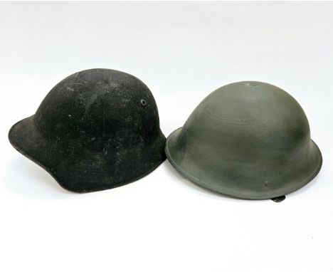 A Swiss M18/40 helmet together with a post-war British Army helmet (2) 