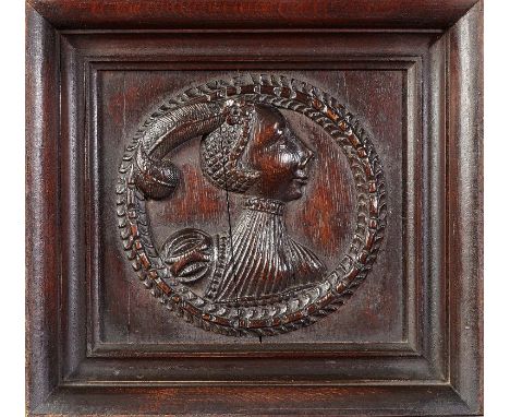 A Henry VIII carved oak Romayne-type portrait panel, English, circa 1540Carved in high relief, a female bust, wearing an exag