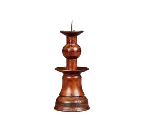 A rare yew bell-base and ball-knopped pricket candlestickProbably Elizabeth I, circa 1600With broad flange centred by a slend