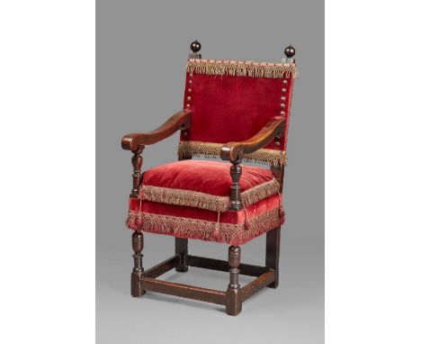 A rare Elizabeth I walnut and upholstered armchair, circa 1580  The rectangular back, squab-cushion and seat upholstered in c