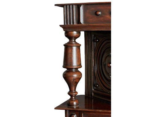 A rare, small and narrow Charles I oak, elm and fruitwood canted cupboard, in the Laudian Manner, circa 1630Having a one-piec