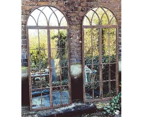 ARCHITECTURAL GARDEN MIRRORS, 180cm high, 75cm wide, a pair, gated design. (2) 