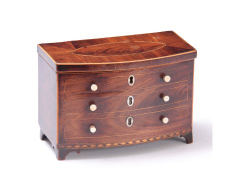 AN UNUSUAL GEORGE III INLAID MAHOGANY TEA CADDY FORMED AS A BOW FRONT CHEST with hinged lid above three dummy drawers fitted 
