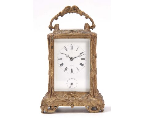 A MID 19th CENTURY FRENCH GILT BRASS ROCOCO STYLE CARRIAGE CLOCK the ornate case with leaf work decoration enclosing a porcel
