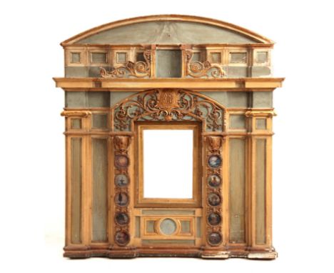 AN 18TH CENTURY POLYCHROME PAINTED ITALIAN CARVED WALL PANEL with architectural pediment above an arcaded panelled front havi