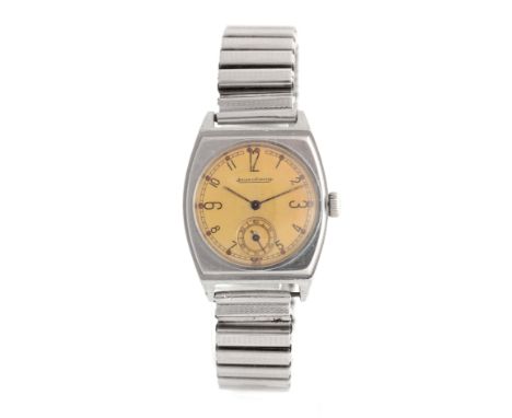 A GENTLEMAN'S 1940's STEEL JAEGER-LECOULTRE WRIST WATCH on later steel strap, the tonneau-shaped screw back case enclosing a 