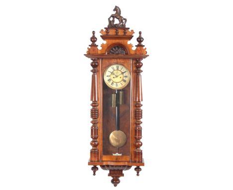 A 19TH CENTURY 8-DAY DOUBLE WEIGHT VIENNA WALL CLOCK with horse-mounted crest and columns to the sides, the enamel dial front