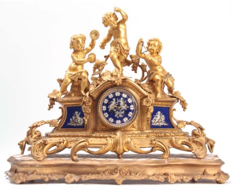 A LARGE 19th CENTURY FRENCH ORMOLU AND LIMOGES PANELLED FIGURAL MANTEL CLOCK the case surmounted by cherubs playing instrumen