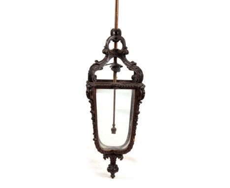 A 19TH CENTURY CARVED OAK FRENCH HANGING LANTERN of Rococo design with glazed sides and leaf work decoration 88cm high - moun