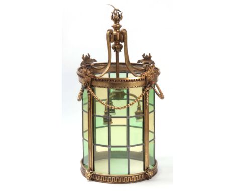 A LARGE 19TH CENTURY STYLE BRASS HALL LANTERN of cast design with triple scrollwork suspending hook, triple bulb holder and g
