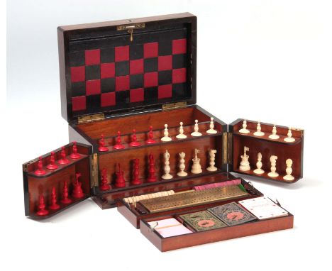 A VICTORIAN ROSEWOOD GAMES COMPENDIUM with hinged fold-out front and lid enclosing a fitted chess set, lift-out tray with dra