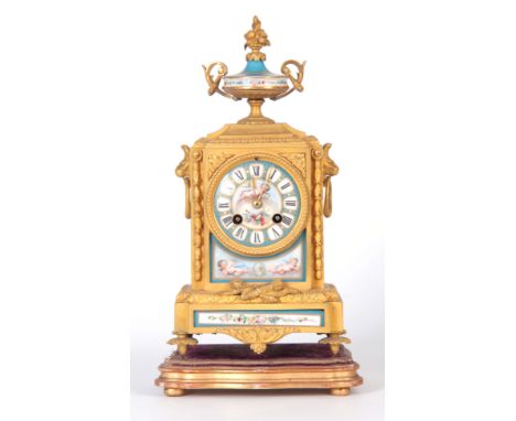 A LATE 19TH CENTURY FRENCH ORMOLU AND PORCELAIN PANELLED MANTEL CLOCK surmounted by an urn finial above an ormolu case with l