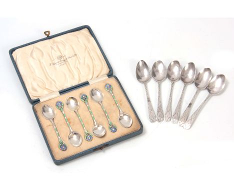 A STYLISH CASED SET OF SIX GEORGE V SILVER AND COLOURED ENAMEL COFFEE SPOONS with leaf and flower head handles Birmingham 193