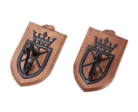 ROBERT (MOUSEMAN) THOMPSON. A PAIR OF SHIELD SHAPED WALL HANGING BRACKETS with painted ironwork mounts 25cm high 15cm wide 18