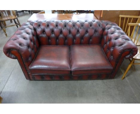 A red leather Chesterfield sofa