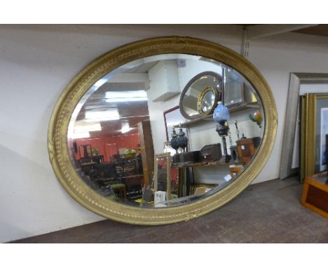 A Victorian oval giltwood framed mirror