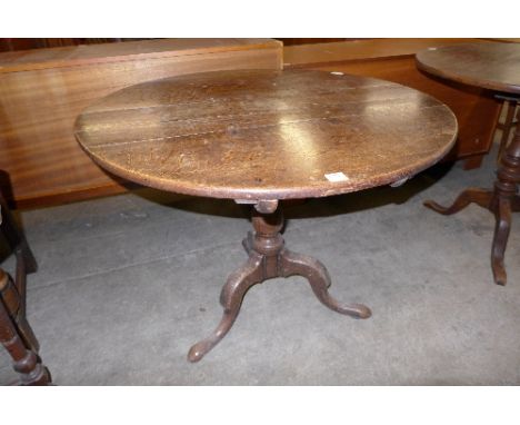 A George III oak circular tilt-top tripod table