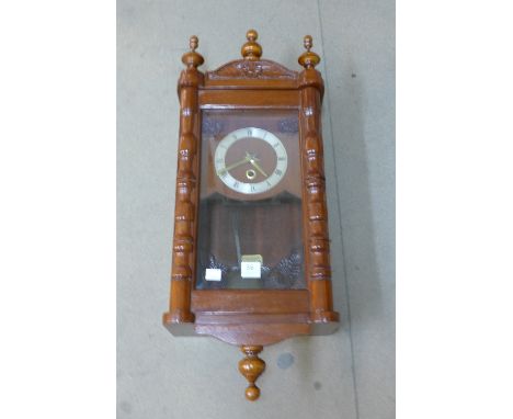 A mahogany wall clock with fusee movement