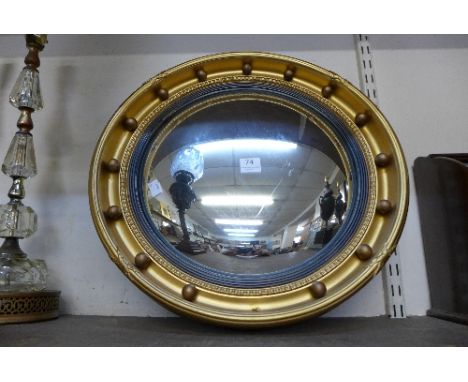 A Regency style gilt framed circular convex mirror