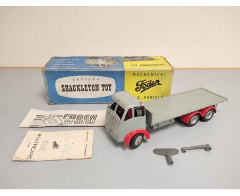 Shackleton Toys. Vintage die cast Foden F.G clockwork flatbed lorry with grey body and red chassis. With original box, key &a