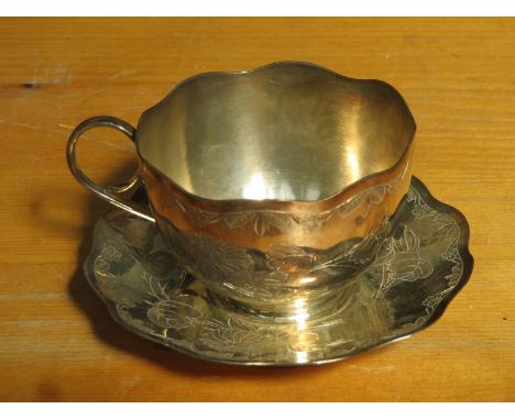 CHINESE SILVER FLORAL DECORATED CUP AND SAUCER