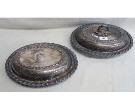 PAIR OF ORNATELY DECORATED SILVER PLATED ENTREE DISHES WITH COVERS, ONE HANDLE DEFICIENT 