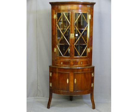 A MAHOGANY STANDING CORNER CUPBOARD, early to mid 20th century two piece bow front, the upper section having twin lattice eff