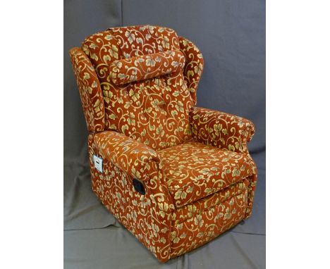A DARK AND FLORAL UPHOLSTERED MANUAL RECLINING CHAIR